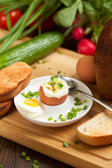 Boiled egg with crunchy bread and healthy vegetables for breakfast
