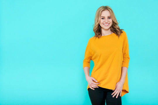 Beautiful Sexy Young Woman In Casual Clothes Studio Portrait On Pastel Blue Background. Attractive Young Woman Colored Background.