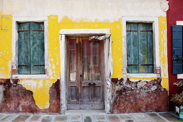 Vintage wall, door and window of a house in Burano island, Venice, Italy