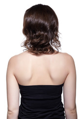 Brunette woman from backside on gray background