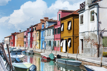 Street with colorful buildings and canal in Burano island, Venice, Italy