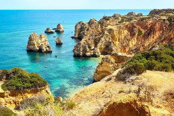 Cliff rocks and sea bay with turquoise water in Lagos, Algarve region, Portugal