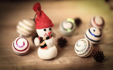 toy snowman and gingerbread house at the Christmas table