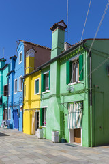 Fototapeta na wymiar Colorful facades with vibrant colors in famous fishermen village on the island of Burano, Venice, Italy