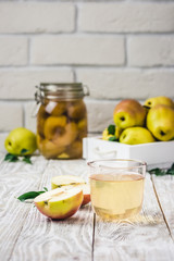 Pear juice on white rustic wooden background. Selective focus, space for text. 