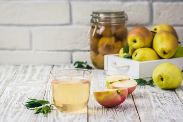 Fresh summer pear drink, canned pear juice on light wooden background. Selective focus, space for text. 