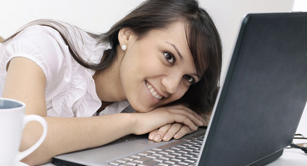 portrait of a young employee behind her Desk.