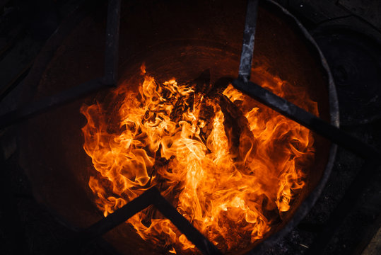 Burning Garbage In Barrel. Background Image Of Flame. Wood In Fire.