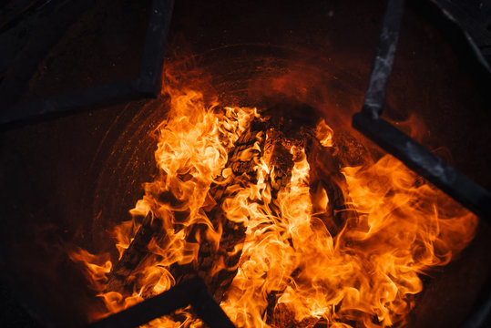 Burning garbage in barrel. Background image of flame. Wood in fire.