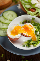 Boiled egg with crunchy bread and healthy vegetables for breakfast