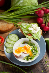 Boiled egg with crunchy bread and healthy vegetables for breakfast