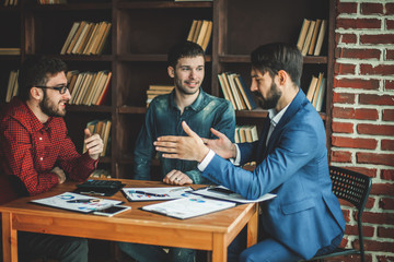 business team makes the analysis of marketing reports at the wor