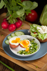 Boiled egg with crunchy bread and healthy vegetables for breakfast