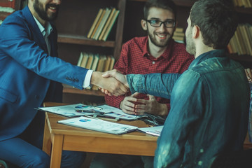 Fototapeta premium business partners shake hands after discussing the contract at t
