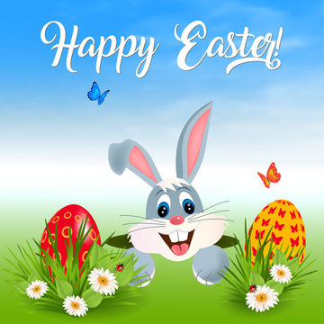 Happy Easter greeting card with green grass, flowers, Easter eggs and hiding bunny.
