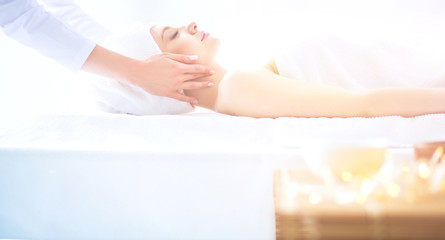 Young woman lying on a massage table,relaxing with eyes closed