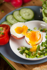 Boiled egg with crunchy bread and healthy vegetables for breakfast