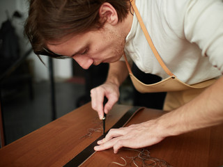 Chamfering with a leather belt by a tanner.