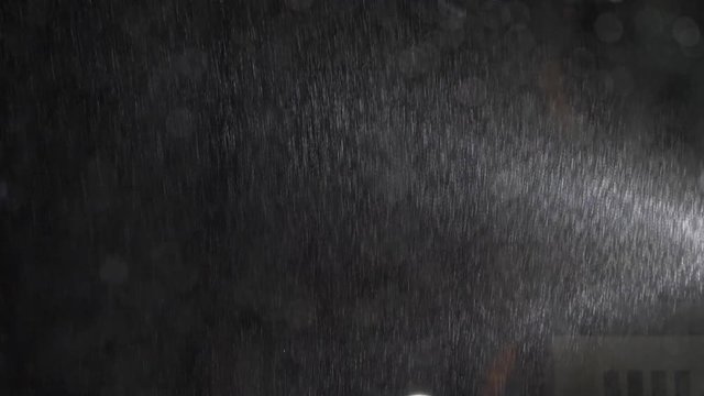 Dramatic rack focus shot of rainstorm. View from house window.