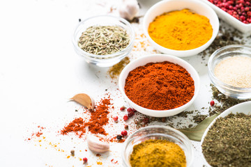 Various spices in a bowls on white.