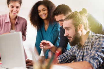 Multiracial business team working together around a laptop  