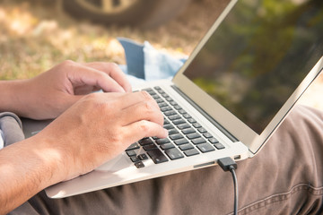 Close up Man's hand are using their laptops on the legs