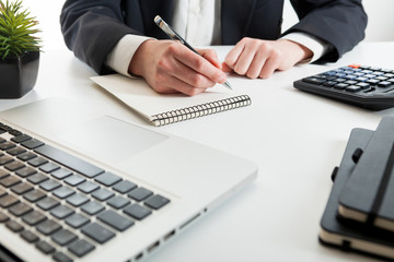 Close up view of bookkeeper or financial inspector hands making report, calculating or checking balance. Marketing strategy brainstorming. Paperwork and digital in office.