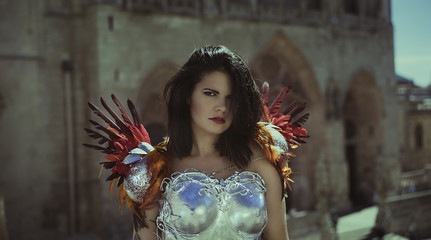 Silver armor, Beautiful brunette woman wearing gold and copper corset in goddess and warrior poses....