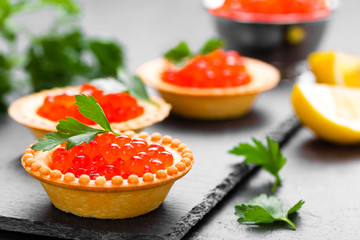 Tartalets with red salmon fish caviar, salmon caviar. Caviar. Selective focus