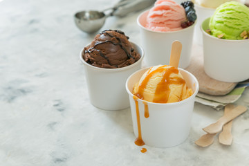 Selection of colorful ice cream scoops in paper cones