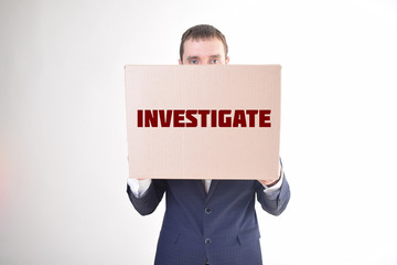 The businessman is holding a box with the inscription:INVESTIGATE