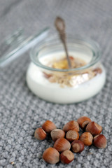 Fototapeta na wymiar Nuts and yogurt with muesli in a jar