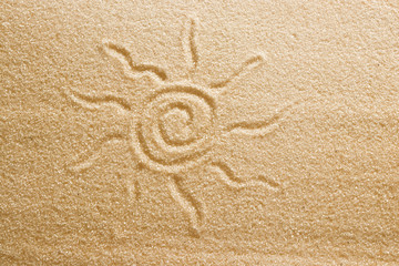 Fototapeta na wymiar The sun is painted in the sand. Beach background. Top view. The concept of summer, summer kanikkuly, vacation, holydays.