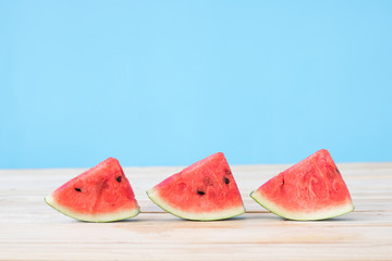 piece of watermelon onf wood table.