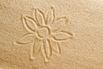 The flower is painted in the sand. Beach background. Top view. The concept of summer, summer kanikkuly, vacation, holydays.