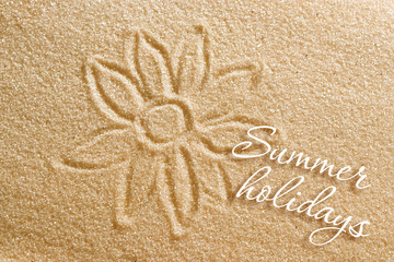 The flower is painted on the sand and the inscription is summer holidays. Beach background. View from above. The concept of summer, summer kanikkuly, vacation, holydays.