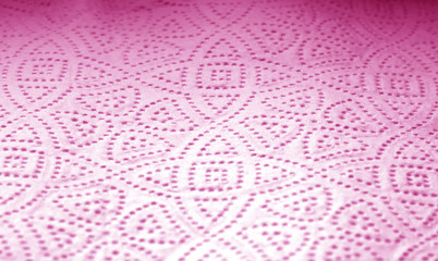 Paper towel surface with blur effect in pink tone.