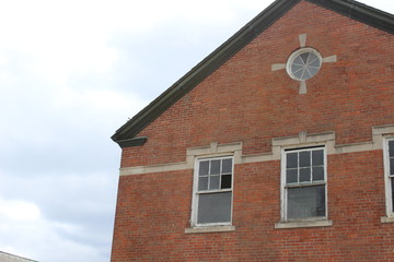 Abandoned and boarded up brick asylum building