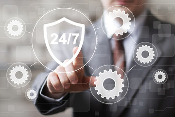 Businessman presses button 24 hours service shield security virus gear engineering network