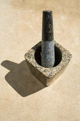 Mortar and pestle on cement background