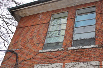 Old abandoned and boarded up brick asylum hospital building