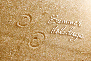 The percent sign is drawn in the sand. Beach background. Top view. The concept of summer, summer kanikkuly, vacation, holydays.