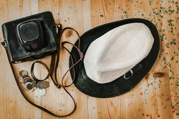 Concept tourism.There is a old photo camera, straw hat and coins