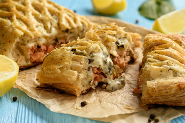Homemade baked salmon with spinach in puff pastry.