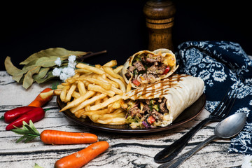 beef tacos served with lettuce and fresh tomatoes
