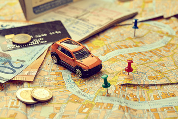 travel concept - small toy car on the map
