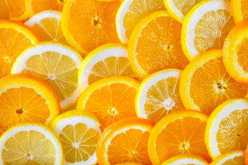 Abstract background of sliced orange and lemon. Close-up view.