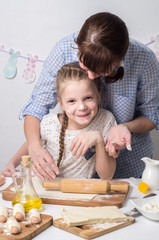 Home Food: Mom and daughter roll out dough.