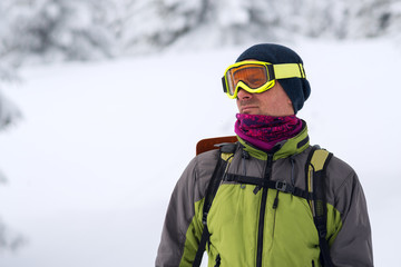 Fototapeta na wymiar Portrait of adventurer in goggles during a winter travel