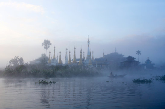 Ancient pagoda and monastery over mist on Inle lake, Shan state, Myanmar
